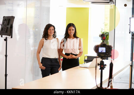 Two women making a corporate demonstration video Stock Photo