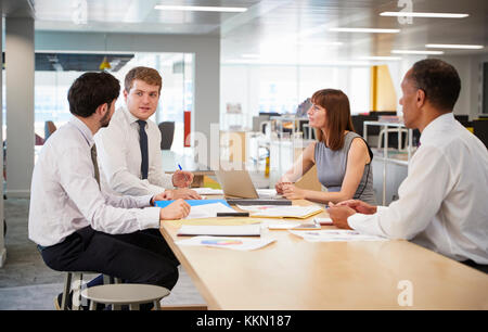 Business colleagues brainstorming in an open plan office Stock Photo