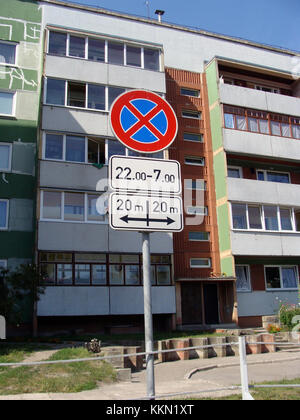 LIEPAJA, LATVIA - AUGUST 16, 2017: Traffic sign prohibiting car parking with time and area limited on background of apartment building. Stock Photo