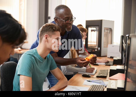 Design Students With Teacher Working In CAD/3D Printing Lab Stock Photo