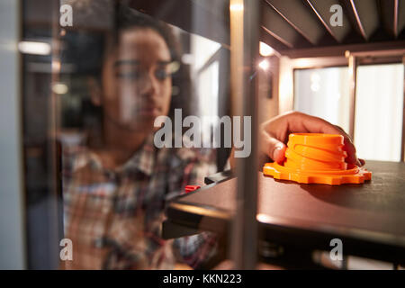 Female College Student Printing 3D Object In Design Lesson Stock Photo