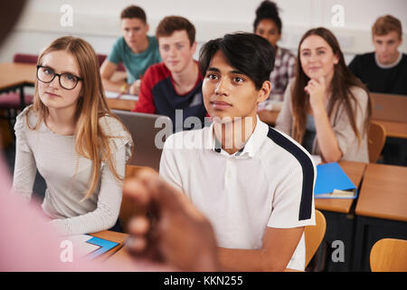 College Students In Class Viewed From Behind Teacher Stock Photo