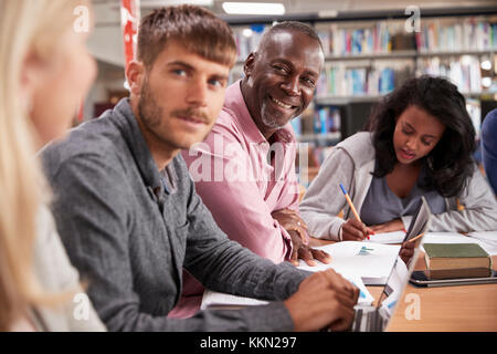 Group Of Mature College Students Collaborating On Project Stock Photo