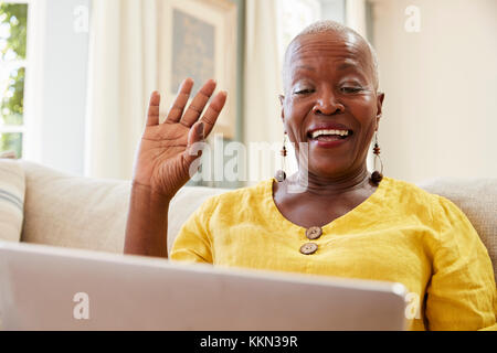 Senior Woman Using Laptop To Connect With Family For Video Call Stock Photo