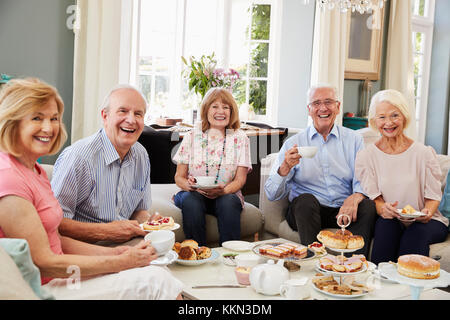 Portrait Of Senior Friends Enjoying Afternoon Tea At Home Stock Photo