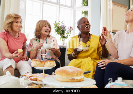 Senior Female Friends Enjoying Afternoon Tea At Home Together Stock Photo