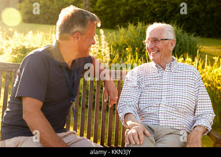 Man Visiting Senior Male Relative In Assisted Living Facility Stock Photo