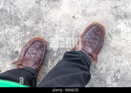 feet of man in green socks in stylish baroque leather boots on a