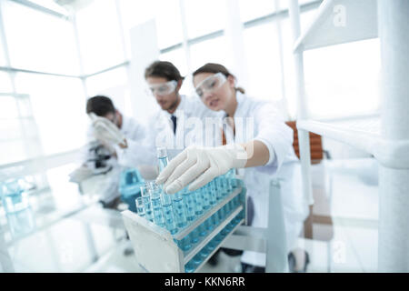 Scientist holding test tube or some equipment of science Stock Photo
