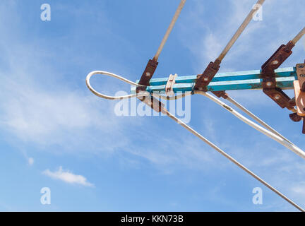 TV antenna, An old television antenna against a blue sky,TV antenna technology obsolescence. Stock Photo