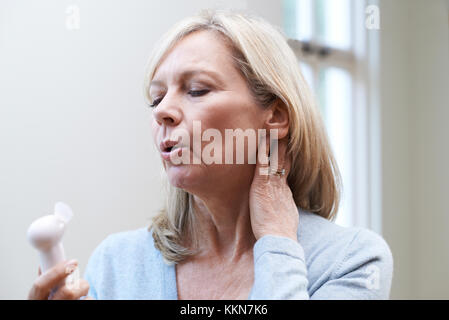 Mature Woman Experiencing Hot Flush From Menopause Stock Photo