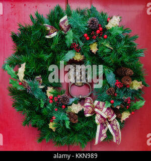 Evergreen wreath on an old door. Stock Photo