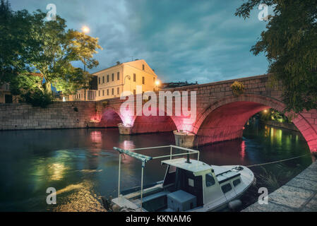 Cityscape with old bridge in city centre at night. Crikvenica, Croatia Stock Photo