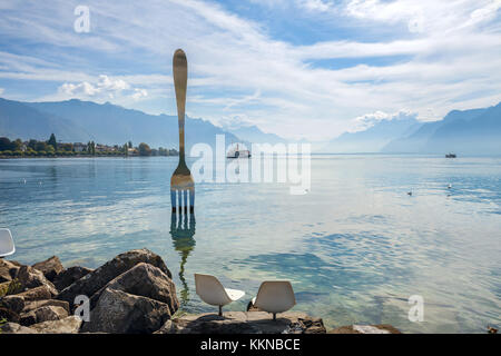 Landscape with fork sculpture in Geneva lake. Artist  Jean-Pierre Zaugg. Vevey, Switzerland Stock Photo