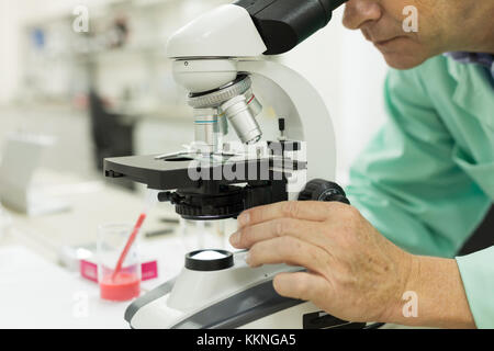 Close-up of a male scientific researcher using microscope in the laboratory. Concept: Research in laboratory Stock Photo