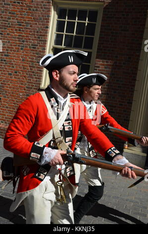 Soldiers dressed in British Army Uniform reinact a key ceremony for tourists in front of The Old State House Boston Massachusetts Stock Photo