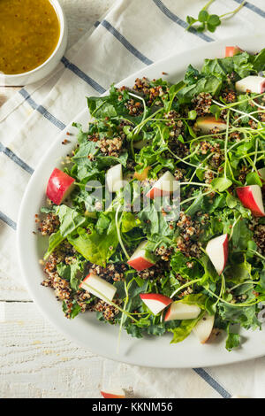 Raw Healthy Organic Kale and Apple Salad with Quinoa and Dressing Stock Photo