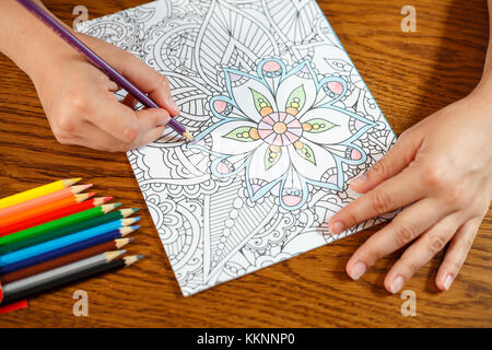 Adult coloring book, stress relieving trend. Art therapy, mental health,  creativity and mindfulness concept. Flat lay close up on woman hands coloring  Stock Photo - Alamy