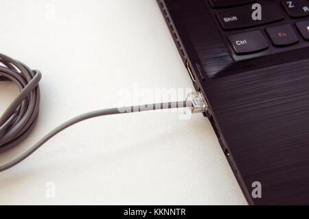 connecting network cable. Network connection concept. connecting cord connection cable. Stock Photo