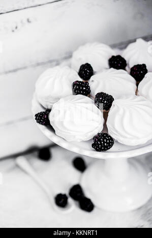 Meringue Cookies Witj Blackberries On Rustic Background Stock Photo