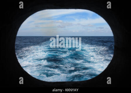 Wake of a Ship at Sea Viewed Through Porthole Stock Photo