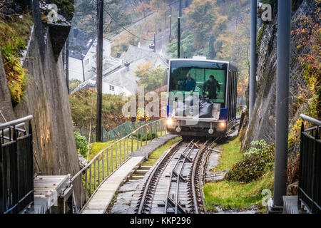 Bergen, Norway -  October 2017 :  Man unloading black bags filled with maintenance materials from the Floibanen funicular heading to the final station Stock Photo