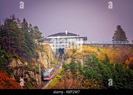 Bergen, Norway -  October 2017 :  The Floibanen funicular heading to the final station at the top of the Mount Floyen, Bergen, Norway Stock Photo