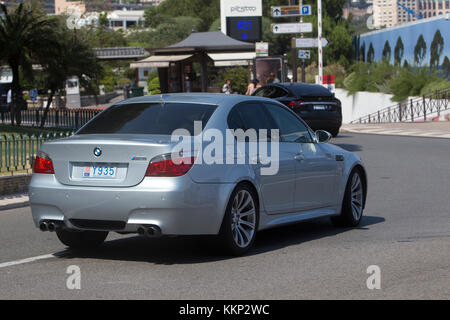 BMW M5 (E60) and Tesla Model X drive on road in Monte Carlo, Monaco Stock Photo