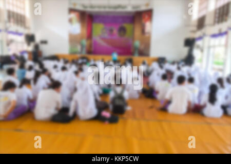 Blurred abstract background of university students sitting in a lecture room with teacher in Conference hall : Blurry view from back of the classroom: Stock Photo