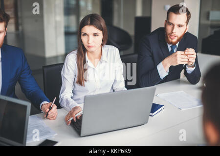 Beautiful young woman working using computer while sitting in workshop Stock Photo