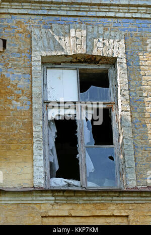 Broken window in an old abandoned house. Stock Photo