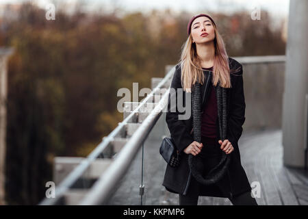 Girl stand on the street and pose to the camera Stock Photo