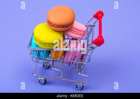 Macaroons in metal shopping basket Stock Photo