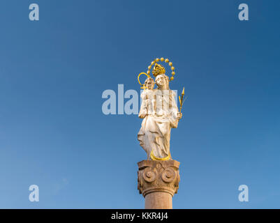 Virgin Mary statue in front of blue sky Stock Photo