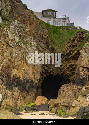 Cave under house on cliff Stock Photo