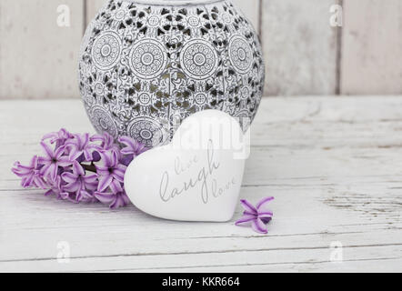 Hyacinth flowers with vase and heart shape, close up, still life Stock Photo