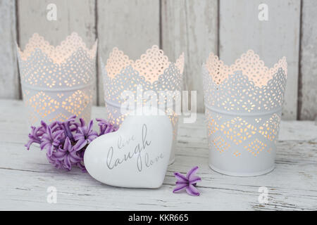 Candles in pots and heart pendant as a decoration, still life Stock Photo