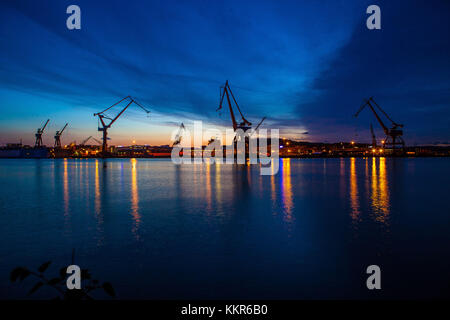 Harbour cranes at dusk, Gothenburg, province of Västra Götalands län, Sweden Stock Photo