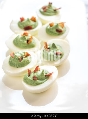 Spinach and bacon deviled eggs Stock Photo