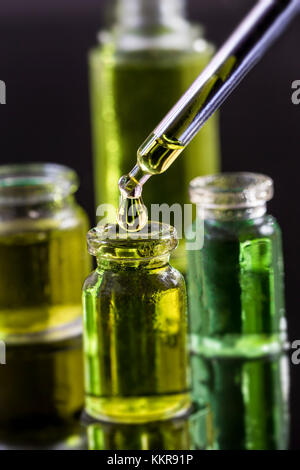 Pure organic aroma essential oil in glass bottle isolated on black background beauty treatment. Fragrant oil spa concept wellness setting Stock Photo