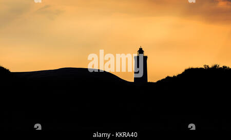 Silhouette of The lighthouse Rubjerg Knude in Denmark Stock Photo