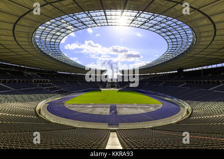 The Olympiastadion Berlin is a sports stadium in Berlin, Germany. It was originally built for the 1936 Summer Olympics by Werner March. During the Olympics, the record attendance was thought to be over 100,000. Today the stadium is part of the Olympiapark Berlin. Stock Photo