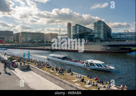 BERLIN, GERMANY, JUNE 25, 2017: View of Main Train Station in Berlin, the Spree and people chilling at open air bars. Stock Photo