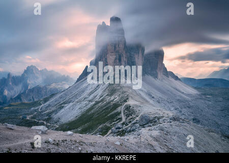 Sunset with clouds on Tre Cime di Lavaredo as seen from Lavaredo fork, Sexten Dolomites, Italy Stock Photo