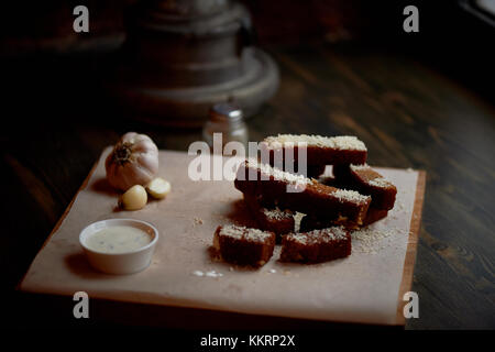 Garlic croutons on a on oiled paper.Photos atmospheric, rough, rustic style. Stock Photo