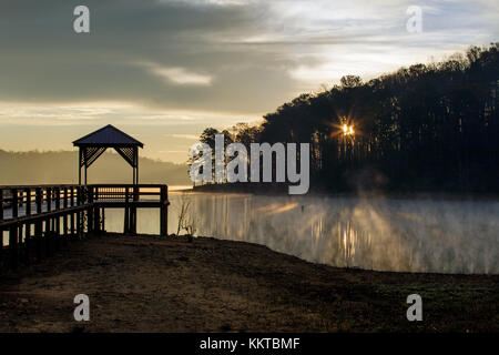 War Hill Park is a large park on the north end of Lake Lanier in Dawsonville, Georgia.  It has campsites, beaches, grills, etc. for overnight and day visitors.  From a photographic standpoint it has a few very interesting features and can be effectively shot at either sunrise and sunset for great reflections.  Lake Sidney Lanier was created in 1956 and is formed primarily by the waters of the Chattahoochee and Chestatee Rivers.  The lake covers 38.000 acres and has over 690 miles of shoreline.  The lake is named after the poet Sidney Lanier. Stock Photo