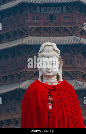 A red robe placed around the Buddha Sakyamuni statue in front of the Wooden Pagoda. Stock Photo