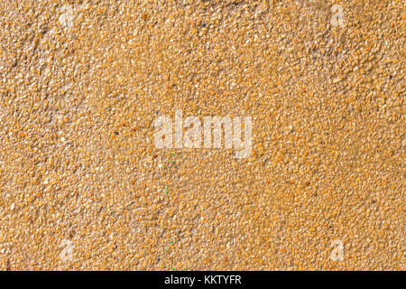 Natural sea sand texture with lacker, rough textured surface of exposed aggregate finish, Ground stone washed floor, made of small sand stone. Stock Photo