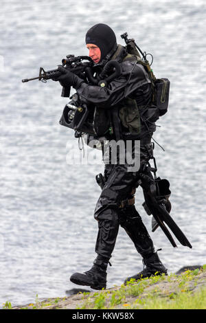 DEN HELDER, THE NETHERLANDS - JUN 23, 2013: Special Forces combat diver during an amphibious assault demo at the Dutch Navy Days. Stock Photo