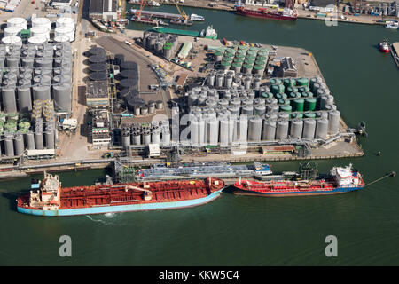Aerial view of a oil and container terminal with moored ships in the Port of Rotterdam. Stock Photo